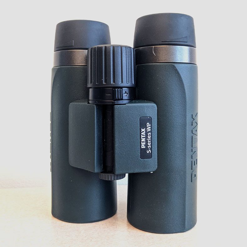 Gray/green binoculars with dark gray eyepieces and focus wheel.
